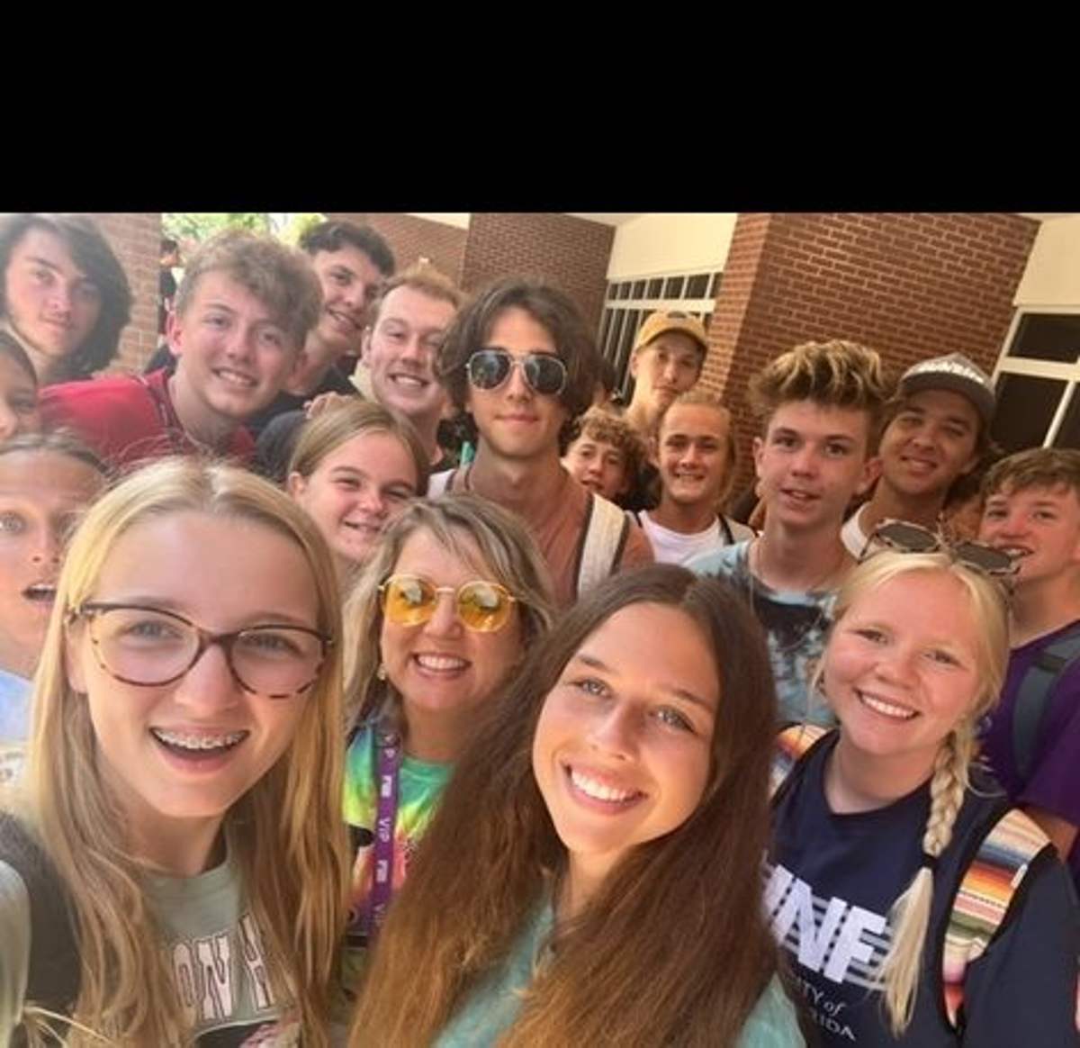 Neptune students smiling together in a group selfie