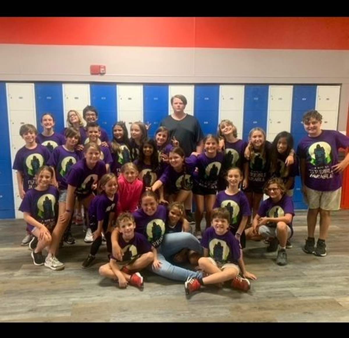 Children in matching camp shirts posing together